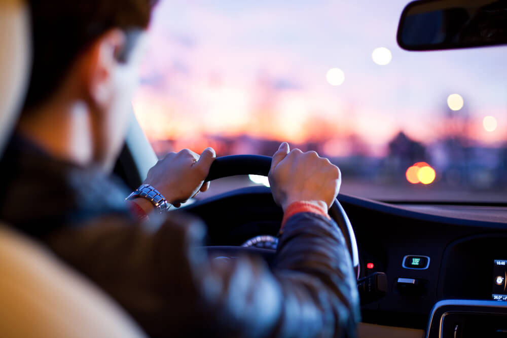 Man driving car in the evening