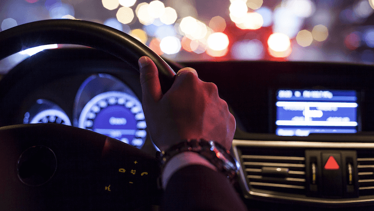 driver with hands on steering wheel